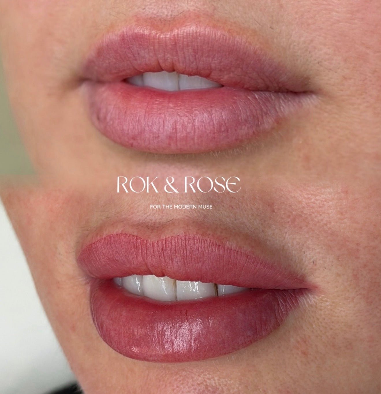 Close-up of a person's lips wearing a rosy pink lip tint, with the text 'ROK & ROSE FOR THE MODERN MUSE' overlaid in the center.