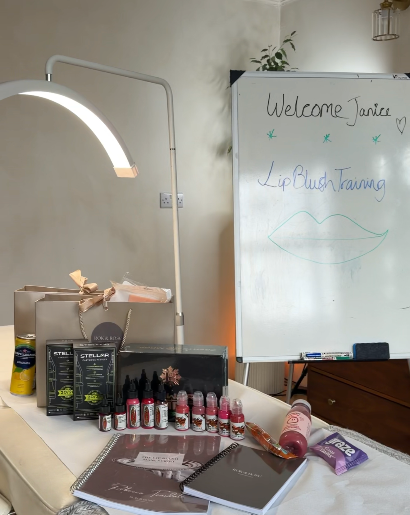 Table with makeup products and a whiteboard in a room setting
